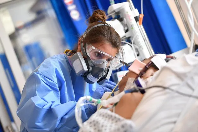 Clinical staff wear Personal Protective Equipment (PPE) as they care for a patent at the Intensive Care unit at Royal Papworth Hospital, during the coronavirus disease (COVID-19) outbreak, in Cambridge, Britain on May 5, 2020. (Photo by Neil Hall/Pool via Reuters)