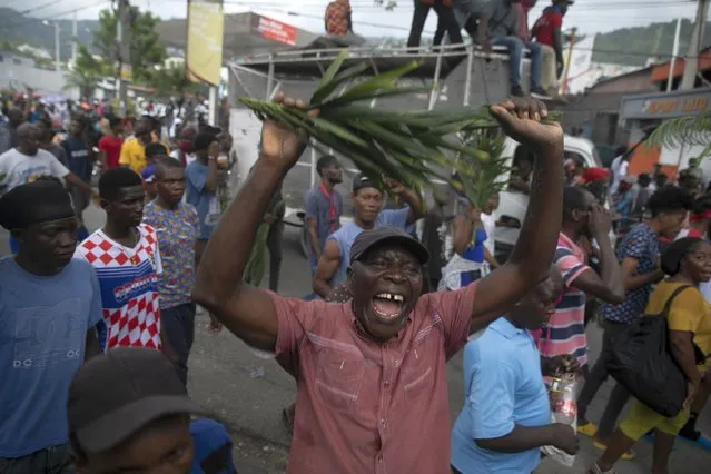 Demonstrators shout during a protest in Port-au-Prince, Haiti, Monday, August 22, 2022. Protesters marched through Haiti's capital and other major cities, blocking roads and shutting down businesses to demand that Prime Minister Ariel Henry step down and call for a better quality of life. (Photo by Odelyn Joseph/AP Photo)