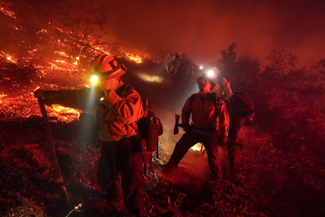 Firefighters battle the Lilac Fire in Bonsall, Calif., Tuesday, January 21, 2025. (Photo by Jae C. Hong/AP Photo)