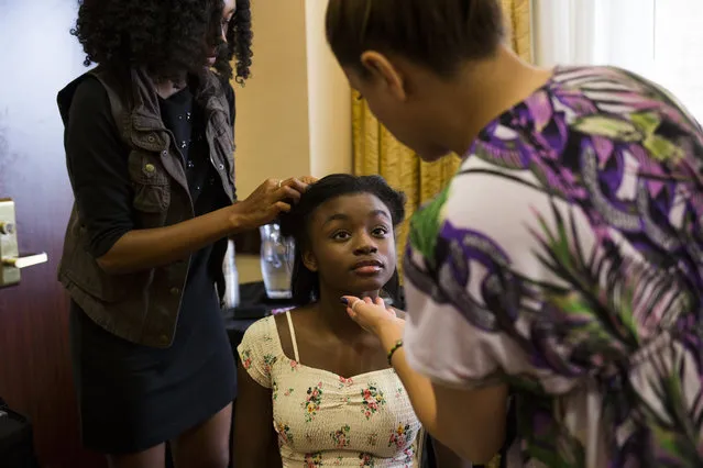 Asya Mercer, 12, of Woodbridge, Va., gets her hair and makeup done before her turn at a photo shoot at a modeling camp at the Courtyard Marriott Hotel in McLean, Va., on Tuesday, August 19th, 2015. (Photo by Brittany Greeson/The Washington Post)