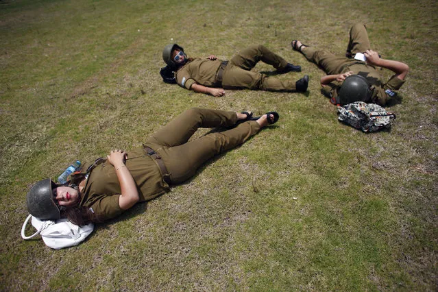 Female Israeli soldiers take part in a drill which envisages a plane crash and the leakage of dangerous substances at the Tel Aviv port June 23, 2011. (Photo by Nir Elias/Reuters)