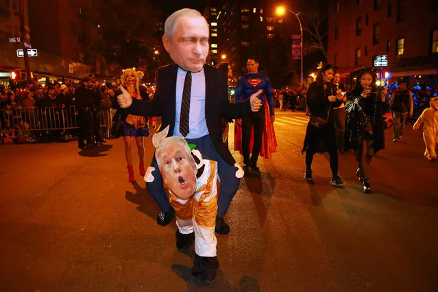 A man dressed as Russian President Vladimir Putin gives a thumbs up marching in the 44th annual Village Halloween Parade in New York City on Tuesday, October 31, 2017. (Photo by Gordon Donovan/Yahoo News)