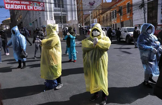 s*x workers wear masks and rains coats during a protest asking the government to ease coronavirus lockdown restrictions in La Paz, Bolivia, Wednesday, June 17, 2020. (Photo by Juan Karita/AP Photo)