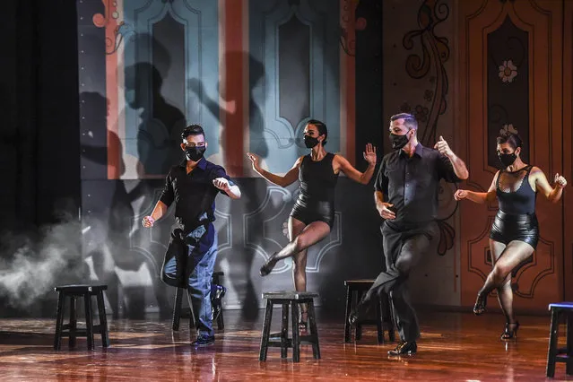 Dancers perform during the XIV International Tango Festival at the Metropolitan Museum in Medellin, Colombia, on June 20, 2020. The Festival took place under special measures to stop the spread of the new coronavirus, where dancers had to wear facemasks, practice social distancing when they perform in groups, dance without a partner in the new solo category and perform without an audience.  Al performances where recorded the week prior to the inauguration of the Festival which will be broadcasted on local TV between the 21st and 28th of June. (Photo by Joaquin Sarmiento/AFP Photo)