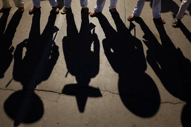 People cast shadows during a parade marking the 114th anniversary of the Mexican Revolution, in Ciudad Juarez, Mexico on November 20, 2024. (Photo by Jose Luis Gonzalez/Reuters)