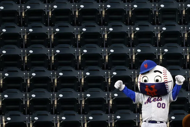 A New York Mets mascot dances in the stands during a break in play in a baseball game between the Atlanta Braves and the Mets on Sunday, July 26, 2020, in New York. (Photo by Adam Hunger/AP Photo)
