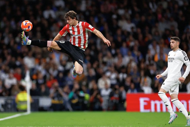 Athletic Bilbao's Spanish midfielder #20 Unai Gomez (L) controls teh ball as Real Madrid's Uruguayan midfielder #08 Federico Valverde looks on during the Spanish league football match between Real Madrid CF and Athletic Club Bilbao at the Santiago Bernabeu Stadium in Madrid, on April 20, 2025. (Photo by Oscar Del Pozo/AFP Photo)