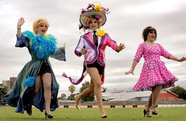 The “Manly Sisters” warm up before joining an attempt to break the Guinness World Record for “The Most People Running in High Heeled Shoes”, in Melbourne on April 10, 2010. Raced over 80 meters, the attempt was unsuccessful but raised money for a foundation which helps support young adults with cancer. (Photo by William West/AFP Photo)