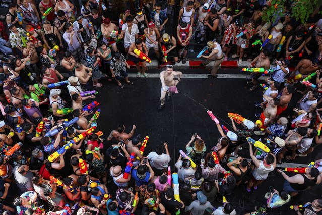 Revellers play with water as they celebrate the Songkran holiday, which marks the Thai New Year, in Bangkok, Thailand, on April 13, 2025. (Photo by Chalinee Thirasupa/Reuters)
