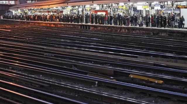 Commuters wait for trains at Clapham Junction train station in London, Monday, January 8, 2018. Thousands of commuters face a week of mayhem from Monday as Southern, Greater Anglia and South Western Railway staff plough ahead with planned strike action. (Photo by Frank Augstein/AP Photo)