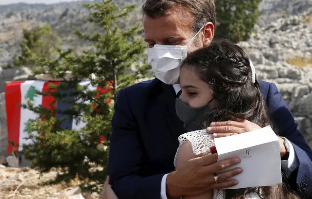 French President Emmanuel Macron hugs blast victim Tamara Tayah after planting a cedar with members of the NGO Jouzour Loubnan in Jaj, near Beirut, Tuesday September 1, 2020. French President Emmanuel Macron returned to Lebanon on Monday, a country in the midst of an unprecedented crisis, for a two-day visit and a schedule packed with events and political talks aimed at charting a way out for the country. (Photo by Gonzalo Fuentes/Pool via AP Photo)