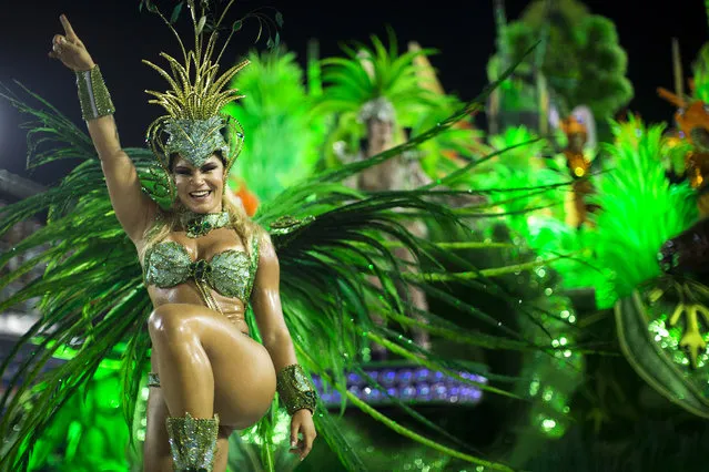 A performer from the Unidos de Vila Isabel samba school parades during Carnival celebrations at the Sambadrome in Rio de Janeiro, Tuesday, February 12, 2013. Rio de Janeiro's samba schools vied for the title of the year's best in an over-the-top, all-night-long Carnival parade at the city's iconic Sambadrome. (Photo by Felipe Dana/AP Photo)