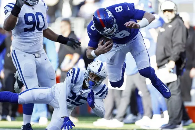 New York Giants quarterback Daniel Jones (8) knocked out of bounds by Indianapolis Colts safety Rodney Thomas II (25) during an NFL football game Sunday, January 1, 2023, in East Rutherford, N.J. (Photo by Adam Hunger/AP Photo)
