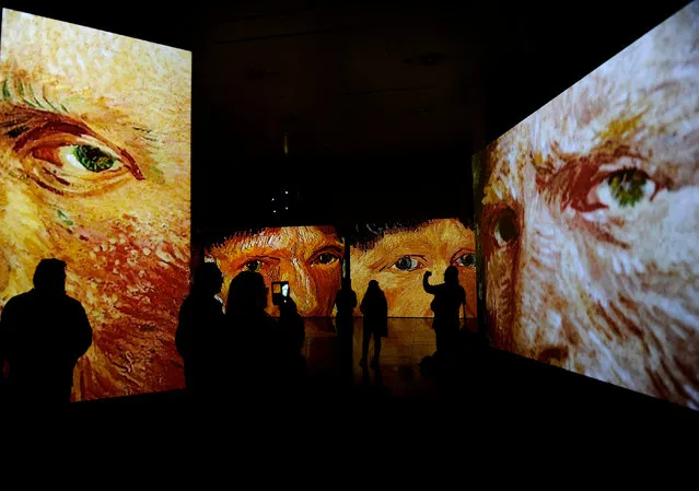 People visit the exhibition “Van Gogh Alive – The Experience”, life and work of Vincent Van Gogh from 1880 until 1890 on February 02, 2018 in Sevilla Photographs and videos combined with a unique system that incorporates over 50 high- definition projectors, graphics and multi- channel surround sound to create multi- screen environments showing the art of Vincent Van Gogh. (Photo by Cristina Quicler/AFP Photo)