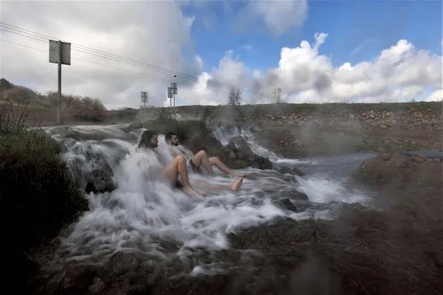 Israelis bath in a hot spring during the winter season, near the settlement of Merom Golan in the Israeli-annexed Golan Heights, on January 17, 2023. (Photo by Jalaa Marey/AFP Photo)