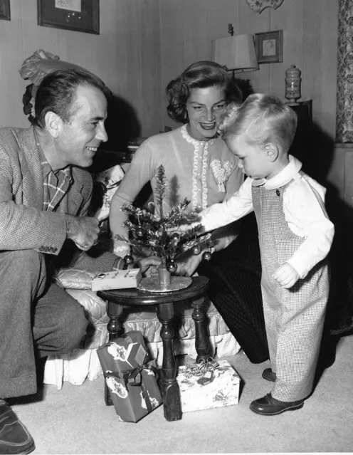 Actor Humphrey Bogart and his wife, actress Lauren Bacall, help their son Stephen decorate a small Christmas tree in their home in Hollywood, Calif., on December 20, 1950. (Photo by AP Photo)