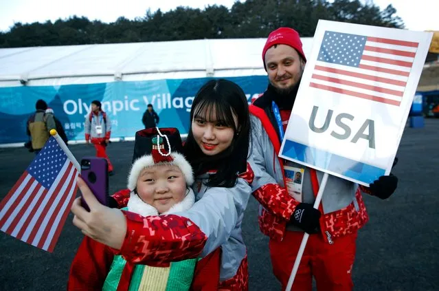Volunteers pose for a selfie before participating in a welcome ceremony for the United State Olympic Team inside the Pyeongchang Olympic Village prior to the 2018 Winter Olympics in Pyeongchang, South Korea, Tuesday, February 6, 2018. (Photo by Patrick Semansky/AP Photo)