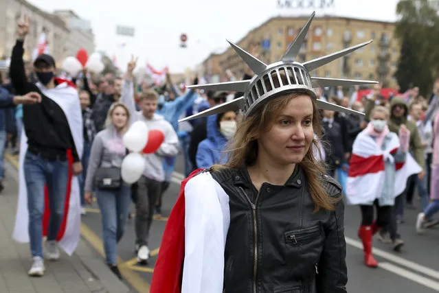 A woman wearing a crown similar to the one on the American statue of Liberty, during an opposition rally to protest the official presidential election results in Minsk, Belarus, Sunday, September 27, 2020. (Photo by TUT.by via AP Photo)