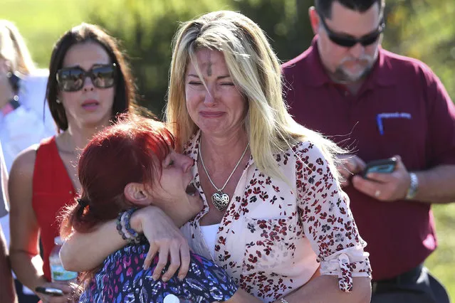 Parents wait for news after a reports of a shooting at Marjory Stoneman Douglas High School in Parkland, Fla., on Wednesday, February 14, 2018. (Photo by Joel Auerbach/AP Photo)