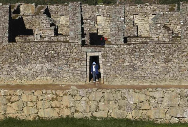 A visitor walks at the Inca citadel of Machu Picchu in Cusco December 2, 2014. (Photo by Enrique Castro-Mendivil/Reuters)