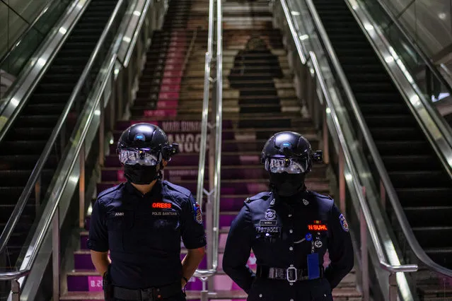 Malaysian Keretapi Tanah Melayu Berhad (KTMB) officers wear smart helmets to measure the body temperature of train passengers in Kuala Lumpur, Malaysia, 14 October 2020. Malaysia tightened coronavirus restrictions between 14 and 27 October 2020 on selective areas, following a spike in COVID-19 cases. (Photo by Ahmad Yusni/EPA/EFE)