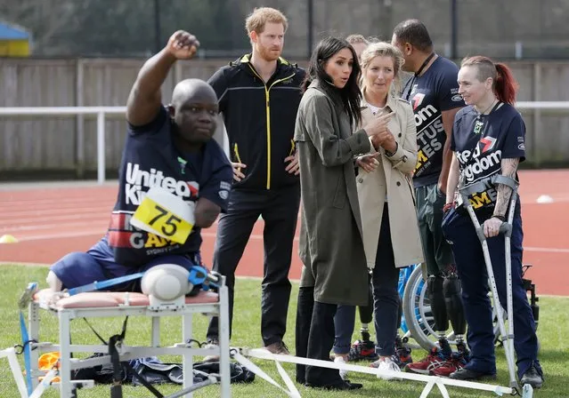 Britain's Prince Harry (2L) and his fiancee US actress Meghan Markle (C) accompanied with Invictus Games UK Team Chef de Mission Jayne Kavanagh (2R) meet participants as they attend the UK team trials for the Invictus Games Sydney 2018 at the University of Bath Sports Training Village in Bath, southwest England on April 6, 2018. The Invictus Games is an international sport event for wounded, injured and sick (WIS) servicemen and women, both serving and veteran. The Games aims to use the power of sport to inspire recovery, support rehabilitation and generate a wider understanding of all those who serve their country. (Photo by Kirsty Wigglesworth/AFP Photo)