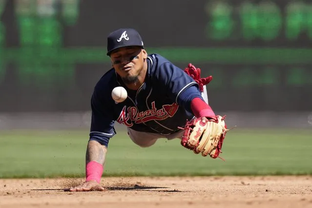 Atlanta Braves shortstop Orlando Arcia loses a pop-up single in the sun that was hit by Washington Nationals' Dominic Smith during the second inning of an opening day baseball game at Nationals Park, Thursday, March 30, 2023, in Washington. (Photo by Alex Brandon/AP Photo)