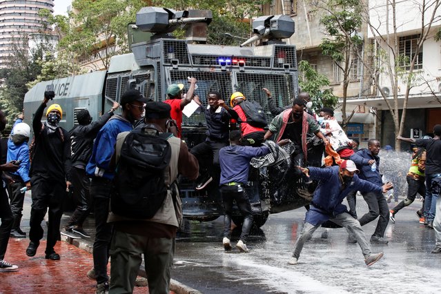 Demonstrators try to obstruct a police vehicle as police use water cannons to disperse protesters during a demonstration against Kenya's proposed finance bill 2024/2025 in Nairobi, Kenya, on June 25, 2024. (Photo by Monicah Mwangi/Reuters)