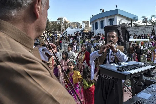 Iraqi Kurds celebrate Nowruz, a Persian New Year, in Sulaimaniyah, Iraq, Monday, March 20, 2023. The Kurdish in Iraq region won de facto self-rule in 1991 when the United States imposed a no-fly zone over it in response to Saddam's brutal repression of Kurdish uprisings. With American invasion 20 years ago much of Iraq fell into chaos, as occupying American forces fought an insurgency and as multiple political and sectarian communities vied to fill the power vacuum left in Baghdad. But the Kurds, seen as staunch allies of the Americans, strengthened their political position and courted foreign investments. (Photo by Hawre Khalid/Metrography via AP Photo)