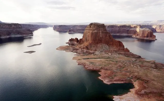 Dry land (R) that would be under water when the lake is full is seen next to Gregory Butte in Lake Powell near Page, Arizona, May 26, 2015. (Photo by Rick Wilking/Reuters)
