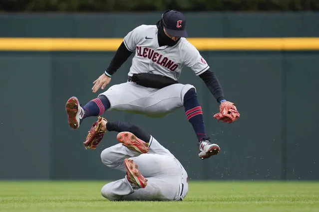 Cleveland Guardians second baseman Andres Gimenez, top, and falls over center fielder Myles Straw on a Detroit Tigers' Javier Baez fly ball in the fourth inning of the second game of a doubleheader baseball game in Detroit, Tuesday, April 18, 2023. (Photo by Paul Sancya)a/AP Photo)