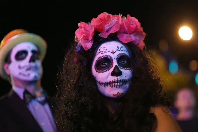 People wear Day of the Dead style costumes at the West Hollywood Halloween Carnaval in West Hollywood in Los Angeles, U.S., October 31, 2016. Picture taken October 31, 2016. (Photo by David McNew/Reuters)