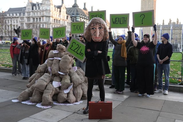 A campaigner dressed in a papier mache head of Chancellor of the Exchequer Rachel Reeves, ahead of a stunt taking aim at her wealth tax at Parliament Square in London on Tuesday, November 25, 2025. (Photo by Stefan Rousseau/PA Images via Getty Images)