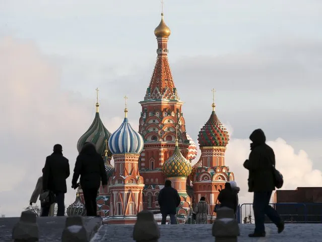 People walk in Red Square, with St. Basil's Cathedral seen in the background, in central Moscow, Russia, in this February 6, 2015 file photo. Russia's central bank is expected to make a rates decision this week. (Photo by Maxim Zmeyev/Reuters)