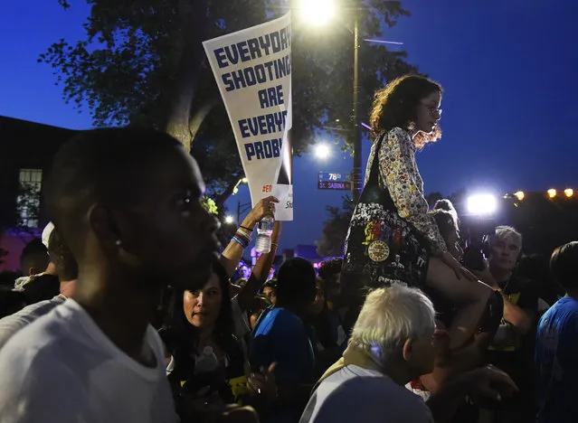 Victoria Gonzalez, right, sits on Manuel Oliver's shoulders during a peace rally and march, Friday, June 15, 2018, in Chicago's South Side. Gonzalez's boyfriend, Joaquin Oliver, was killed this year at a Florida high school shooting. (Photo by Annie Rice/AP Photo)