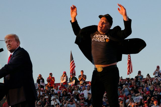 Tesla CEO and X owner Elon Musk reacts next to Donald Trump during a campaign rally, at the site of the July assassination attempt against Trump, in Butler, Pennsylvania, on October 5, 2024. (Photo by Brian Snyder/Reuters)