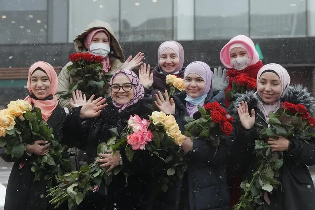 Muslim women, who live in Ukraine, hold flowers as they mark the World Hijab Day in Kiev, Ukraine, 01 February 2021. A hijab is a shawl worn by Muslim women that covers the hair, head, and chest. World Hijab Day was founded in 2013 and mark on 01 February each year in 140 countries. (Photo by Sergey Dolzhenko/EPA/EFE)