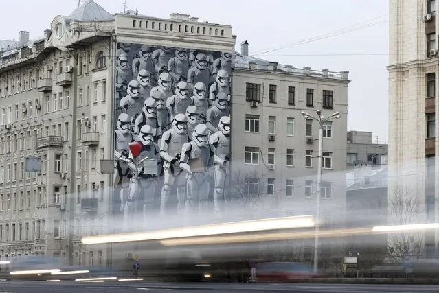 Cars drive past a building decorated with a mural depicting Stormtroopers characters from the movie Star Wars in Moscow, Russia, December 14, 2015. The Russian premiere of “Star Wars: The Force Awakens” will take place in Moscow on Thursday, December 17. (Photo by Maxim Shemetov/Reuters)