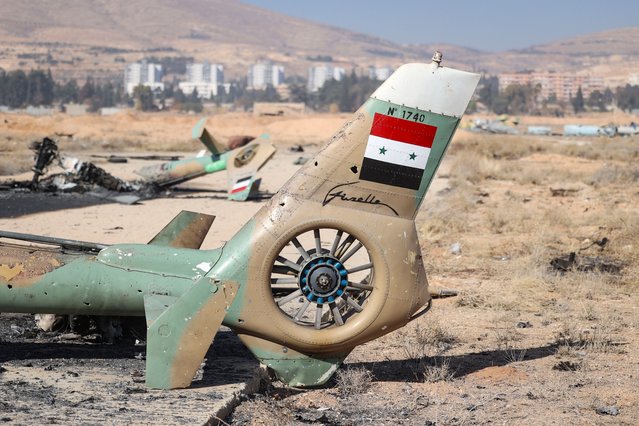 A destroyed helicopter on the ground at the Mezzeh Air Base on the outskirts of Damascus, Syria, 16 December 2024. After Syrian rebels ousted President Bashar al-Assad on 08 December 2024, the Israeli military carried out strikes throughout Syria to destroy what remained of the Assad regime's military arsenal. (Photo by Antonio Pedro Santos/EPA/EFE)