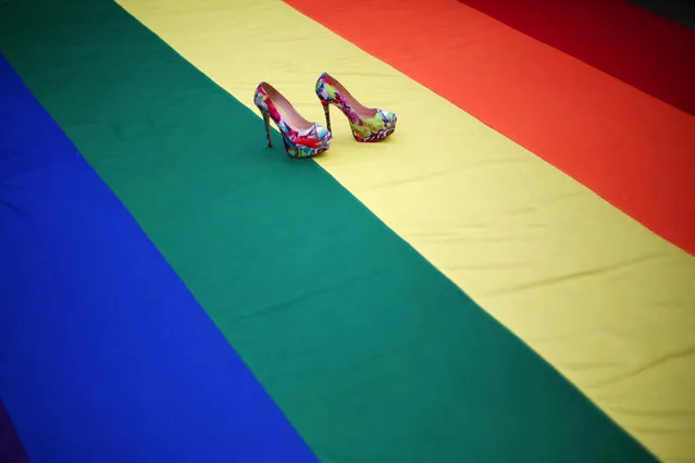 high heel shoes are seen on a rainbow flag during a protest by the LGBT community against violence against transgenders outside Metropolitan Cathedral in Mexico City, Mexico, November 13, 2016. (Photo by Edgard Garrido/Reuters)