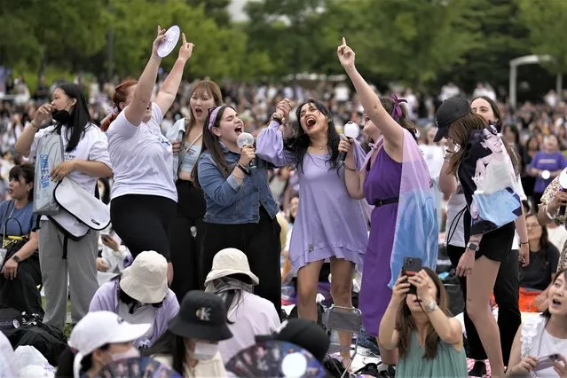 Fans of BTS gather during an event to celebrate the 10th debut anniversary of K-pop band BTS at a public park near the Han River in Seoul, South Korea, Saturday, June 17, 2023. Seoul officials hope that the celebrations, which will continue for around two weeks, will boost tourism. The city has designated more than a dozen sites associated with BTS, including places where the group held major performances or shot some of their famous videos. (Photo by Lee Jin-man/AP Photo)
