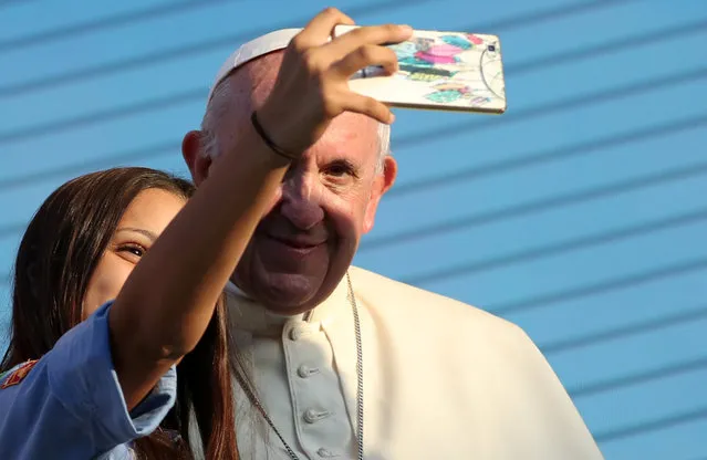 Pope Francis takes a selfie with a faithful as he meets with young people at the Politeama Square in Palermo, Italy, September 15, 2018. (Photo by Tony Gentile/Reuters)