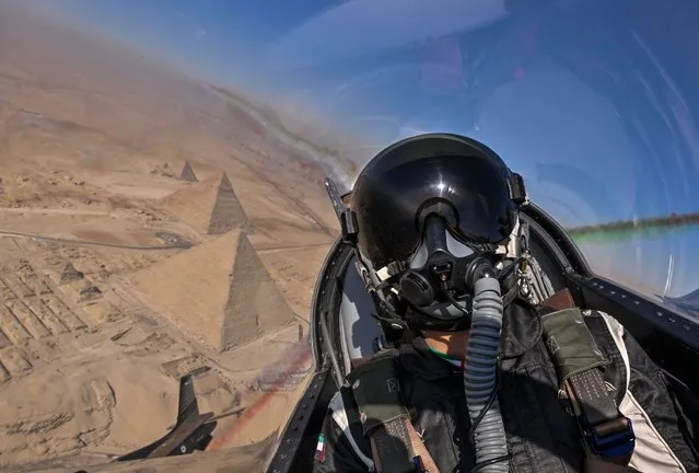 Pilots from Al Fursan, the UAE Air Force and Air Defence aerobatic team, soar over the pyramids at Giza, south of Cairo on July 25, 2023. (Photo by Fursan al Emarat/Twitter)