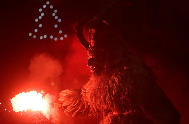A man dressed as a devil performs during a Krampus show, the traditional parade where people in costumes and masks perform an old ritual to disperse the ghosts of winter, in the southern Bohemian town of Kaplice, December 10, 2016. (Photo by David W. Cerny/Reuters)