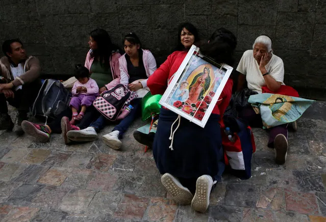 A pilgrim carries an image of the Virgin of Guadalupe at the Basilica of Guadalupe during the annual pilgrimage in honor of the Virgin of Guadalupe, patron saint of Mexican Catholics, in Mexico City, Mexico December 11, 2016. (Photo by Henry Romero/Reuters)