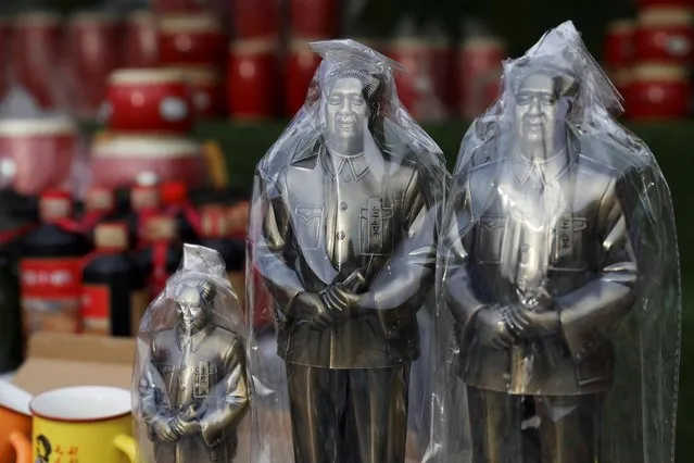 Statues of late Chinese chairman Mao Zedong wrapped in plastic are seen displayed at a souvenir stall at Nanniwan, a former revolutionary base of the Communist Party of China, ahead of the 100th founding anniversary of the party during a government-organised tour in Yanan, Shaanxi province, China on May 11, 2021. (Photo by Tingshu Wang/Reuters)