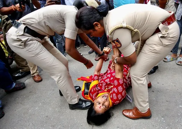 Indian police detain a woman during a protest by pro-Kannada activists against the Supreme Court's order on the Cauvery river water dispute and Tamil Nadu chief minister in Bangalore, India, 26 September 2023. Hundreds of farmers and pro-Kannada activists staged a protest calling for a “Bangalore Bandh” and Section 144 implemented across the city, following the Indian Supreme Court's order and the Cauvery Water Management Authority (CWMA) order directed Karnataka to continue releasing 5,000 cusecs of water to Tamil Nadu for another 15 days. (Photo by Jagadeesh N.V./EPA/EFE)