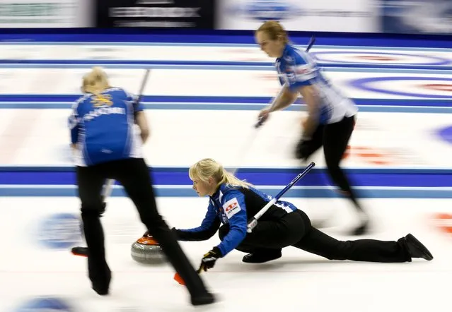 Finland's skip Saana Puustinen (C) delivers a stone as her team mates Marjo Hippi (R) and Oona Kauste prepare to sweep during their curling round robin game against Germany during the World Women's Curling Championships in Sapporo March 16, 2015. (Photo by Thomas Peter/Reuters)