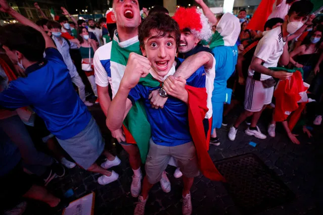 Fans of Italy react after Italy scored their third goal, as they watch at a fan zone on Piazza del Popolo in Rome on June 11, 2021, the EURO 2020 2021 European Football Championship Group A's Turkey vs Italy kick off match. (Photo by Guglielmo Mangiapane/Reuters)