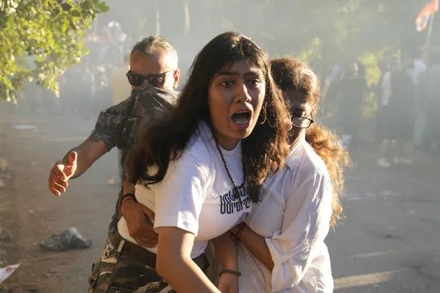 Lebanese Armenian woman reacts to tear gas outside the Azerbaijani embassy in Beirut, Lebanon, on Thursday, September 28, 2023. (Photo by Hussein Malla/AP Photo)